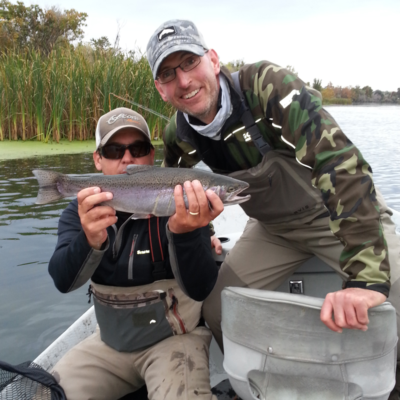 2 smiling guys with a fish.